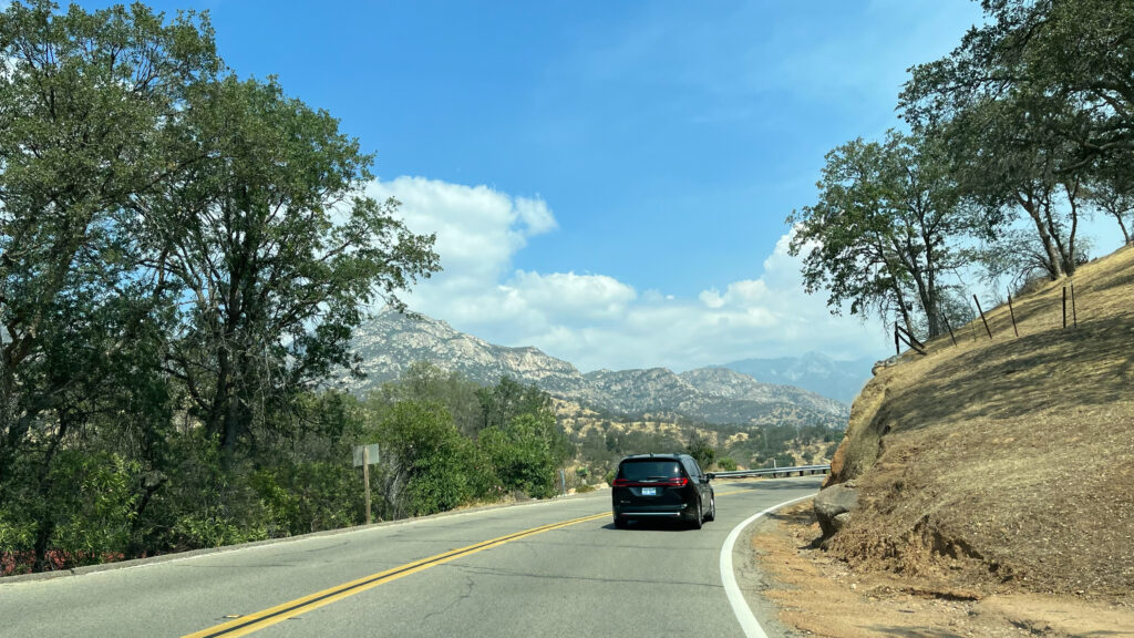 In this photo you can see Moro Rock in the far distance - that was our first glimpse of it! (Moro Rock is in the middle of the bluish mountain area above and to the right of the car in front of ours - it's the part sticks up a bit in the middle of that bluish mountain area) It was exciting to see Moro Rock knowing we would be climbing it later that day.