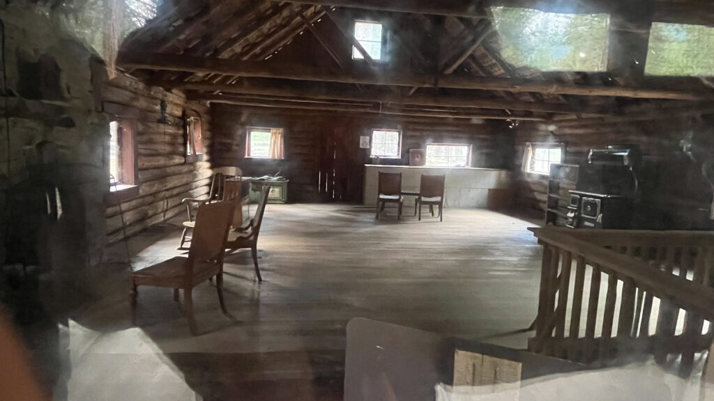 A photo taken through a dusty window of the inside of one of the old homes at the Yosemite History Center in Yosemite National Park (I think this was the home that belonged to the couple who were artists who painted Yosemite, but I'm not sure)