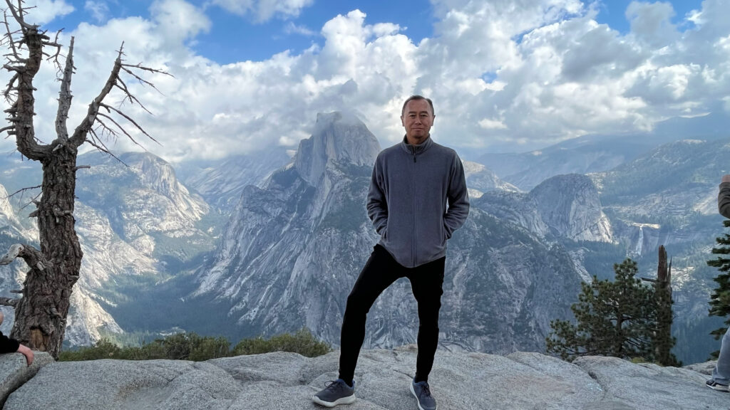 A view of Half Dome and my guy from Glacier Point in Yosemite National Park