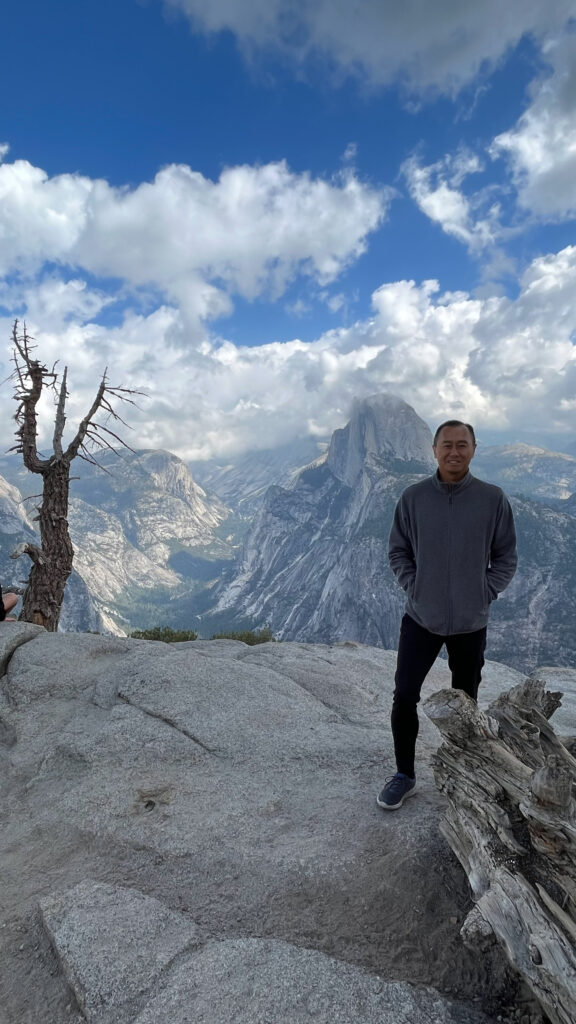 A view of Half Dome and my guy from Glacier Point in Yosemite National Park