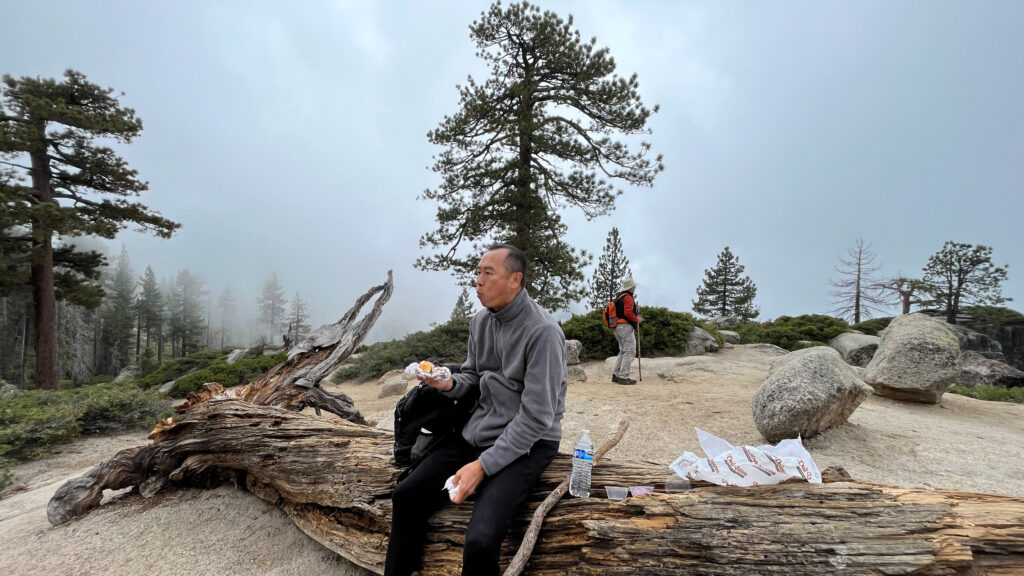 My husband enjoying his sandwich as a thunderstorm is forming in the backdrop at Taft Point in Yosemite National Park. (We put all of our trash and recyclables in our backpack to dispose of later)