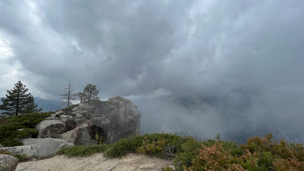 Clouds continue to roll up the mountain from the valley below at Taft Point in Yosemite National Park