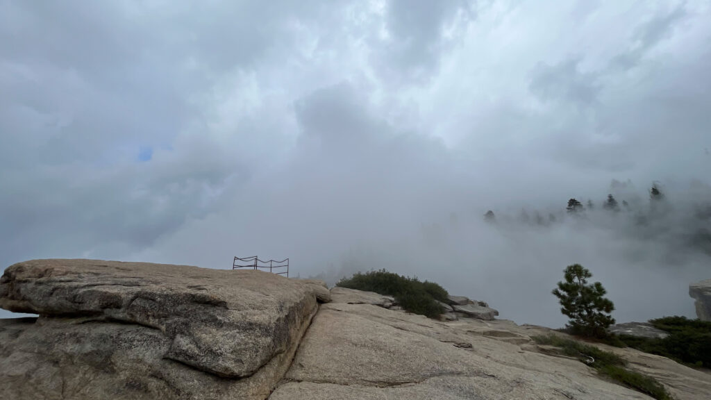 Clouds continue to rush up the mountain from the valley below at Taft Point in Yosemite National Park, and then the thunder and lightning commenced, just about when this photo was taken - time to head away from the high point. Plus, the rocks were starting to get slippery. (We had planned to go up to that area in the photo that has protection around it so we could get a great view from that point, but the weather prevented that from happening)