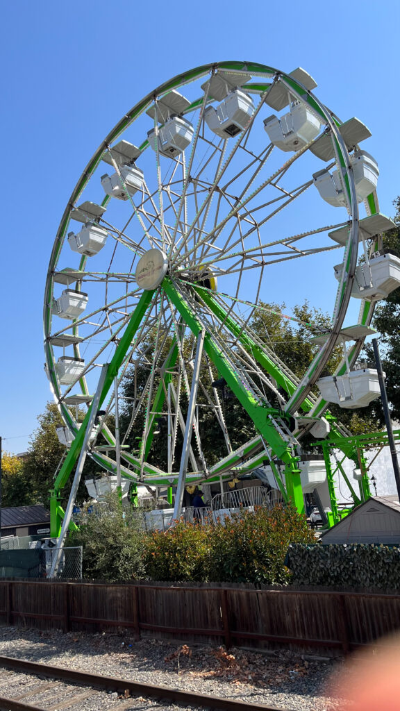 The Waterfront Wheel - a ferris wheel on the boardwalk at Old Sacramento Waterfront, Sacramento, CA (Next to the ferris wheel is Front Street Carousel)