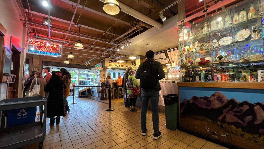 My husband checking out the menu from a place near the table he ate his chowder at (Pike Place Market in Seattle, WA)