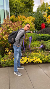 My husband pointing out a piece of purple glass art and making me laugh at Chihuly Garden and Glass. (Seattle, WA)