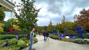 My husband making me laugh as we walk through the garden with various pieces of glass artwork at Chihuly Garden and Glass. (Seattle, WA)