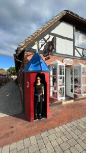 Me standing in an old Danish style phone booth in Solvang, CA