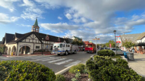 Rasmussen’s gift shop and other Danish style buildings and the Solvang Trolley riding in the road (Solvang, CA)