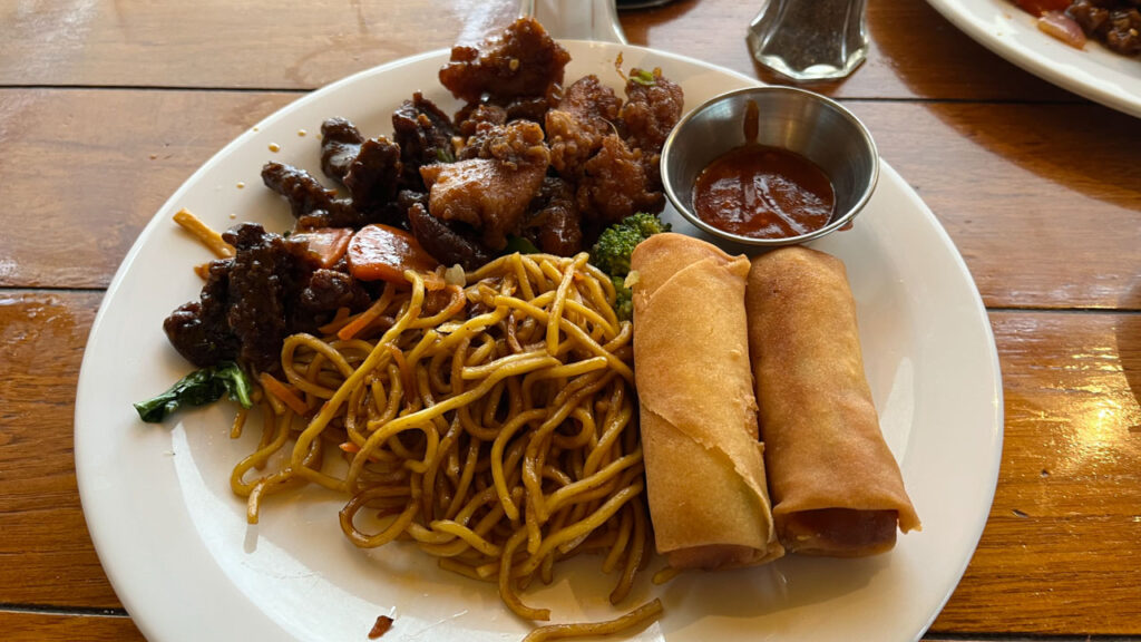 Yummy food from the included Chinese lunch buffet at Seafood Shack on the Carnival Venezia. Shown is Honey Chili Beef, Chicken Kung Pao, Lo Mein and Vegetable Spring Rolls with Hot Garlic Sauce