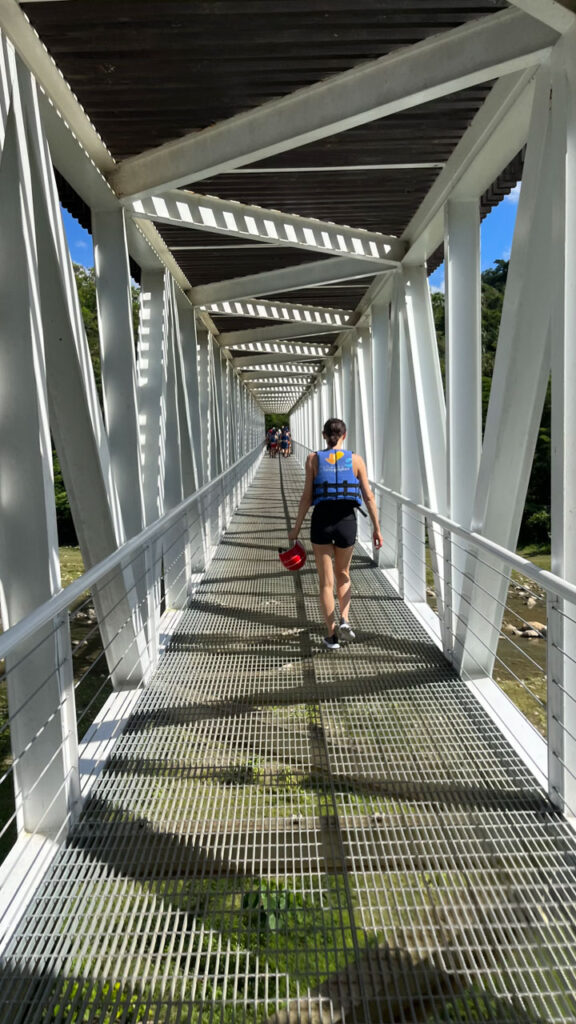 Walking over a bridge to get to the waterfalls at Damajagua 27 Falls in the Dominican Republic