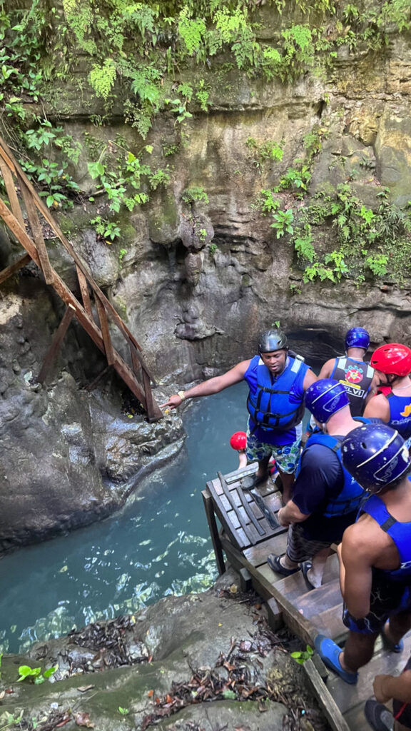 Here you can see our guide (the man facing us) as he directed people at the first of the falls we did that day at Damajagua 27 Falls in the Dominican Republic. On the left side you can jump into the water, and on the right side you can climb into the water. 