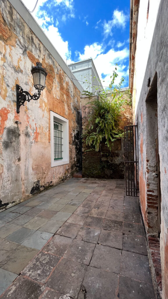 On the left you can see the narrow passage from the back patio of the Puerto Rico Tourism Company on Paseo de la Princesa in San Juan, Puerto Rico that led us to an old, small prison that you can tour for free