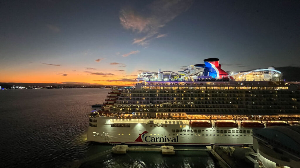 View of the Carnival Celebration from the Carnival Venezia at sunset in San, Juan Puerto Rico as we on the Carnival Venezia were sailing away. People on the Celebration were waving their cell phone flash lights at us as we sailed away.