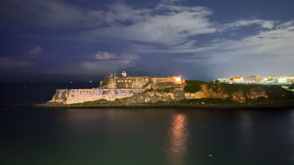 View of Castillo San Felipe del Morro from the Carnival Venezia in San Juan, Puerto Rico as we on the Carnival Venezia were sailing away. (It was hard to get a great shot of Castillo San Felipe del Morro as we sailed by it because they don’t shine lights on it and it was dark when we passed it, but fortunately the long exposure from my camera and holding my camera as still as I could as my iPhone camera took the photo helped me to get a few decent shots of it.)